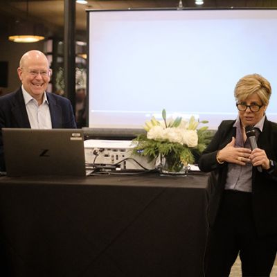 Image of John A and Divot talking in front of a group