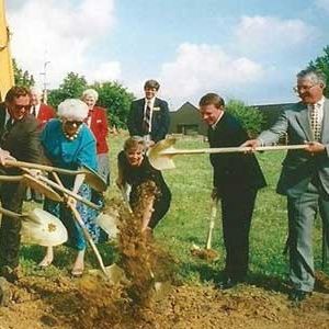 An image of one of our original ground breaking. Retro image of old employees